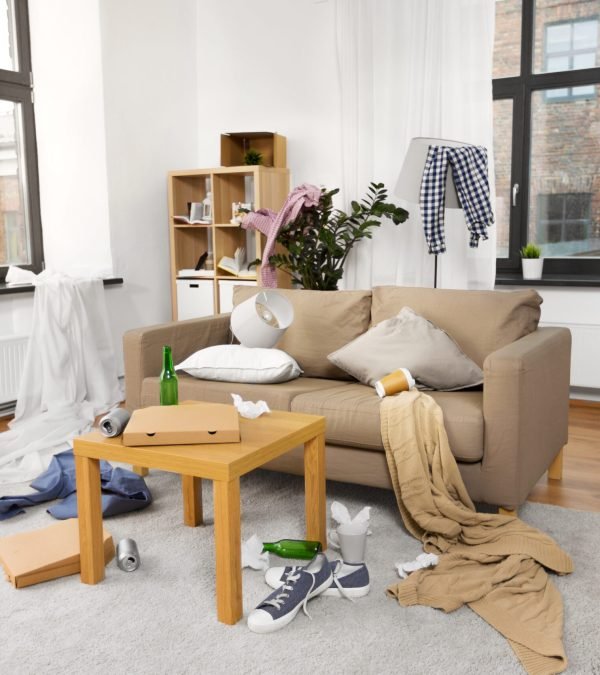 mess, disorder and interior concept - view of messy home living room with scattered stuff